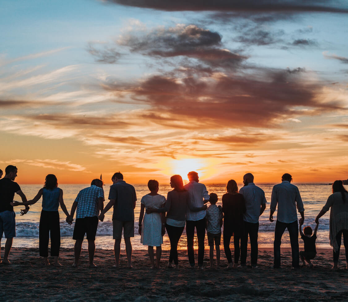 A family on the beach remembering a loved one.